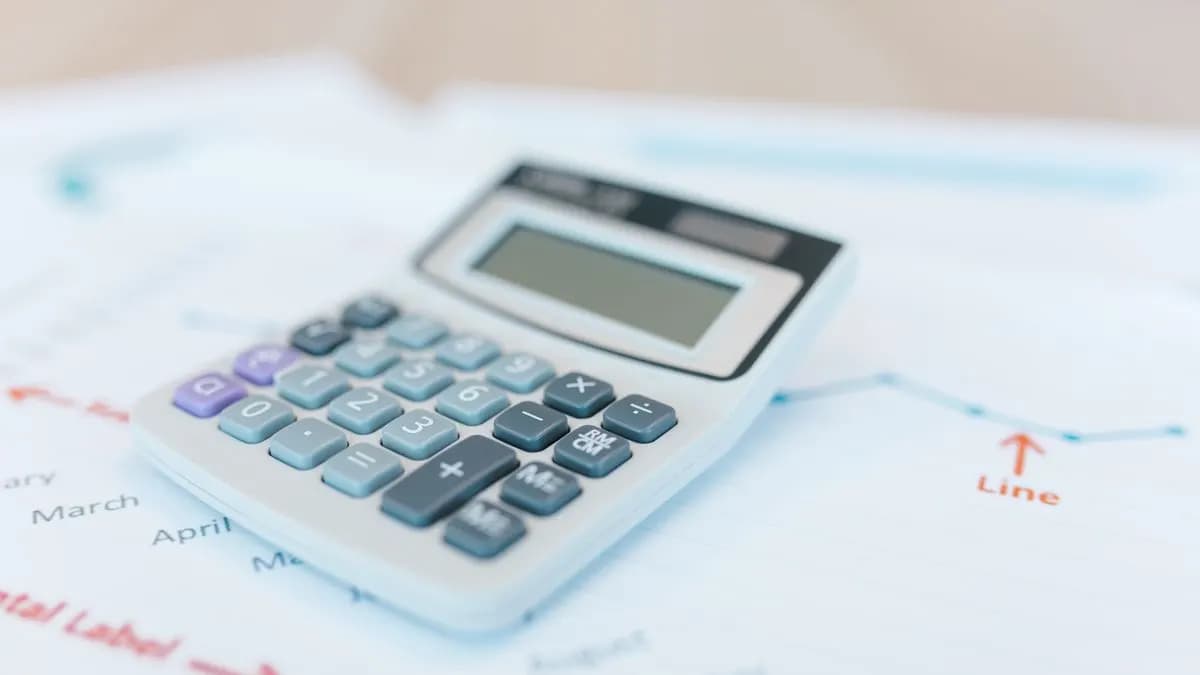 Calculator on financial documents with charts for index-linked rent calculation